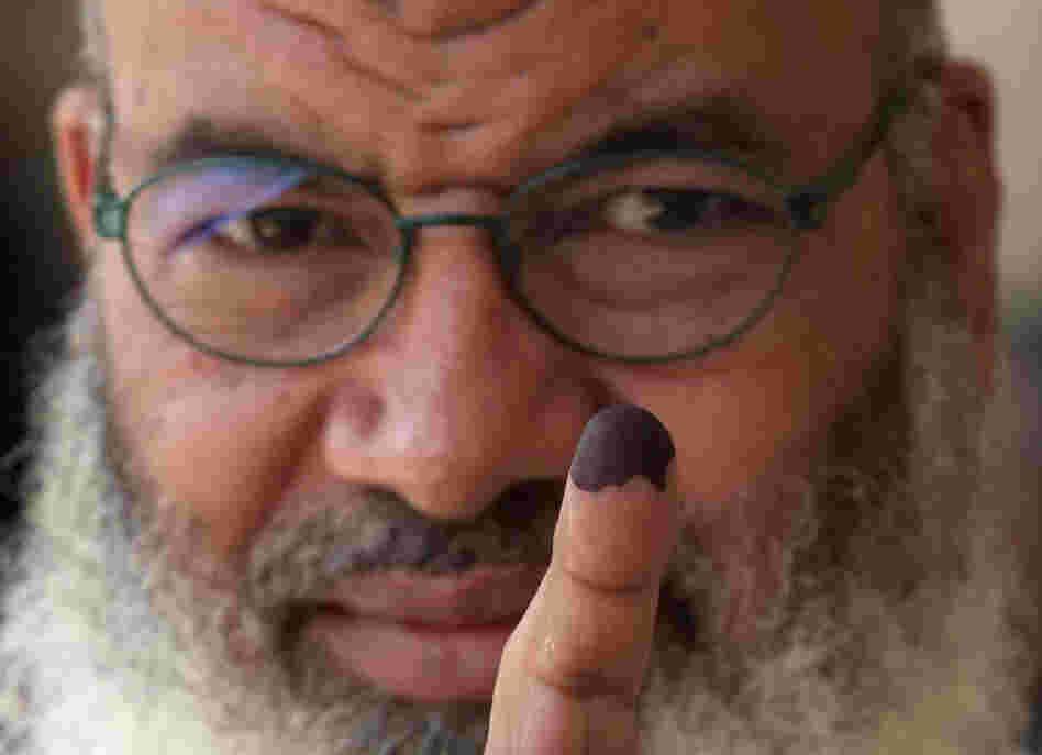 An Egyptian man shows his ink-stained finger after voting in Cairo earlier today.