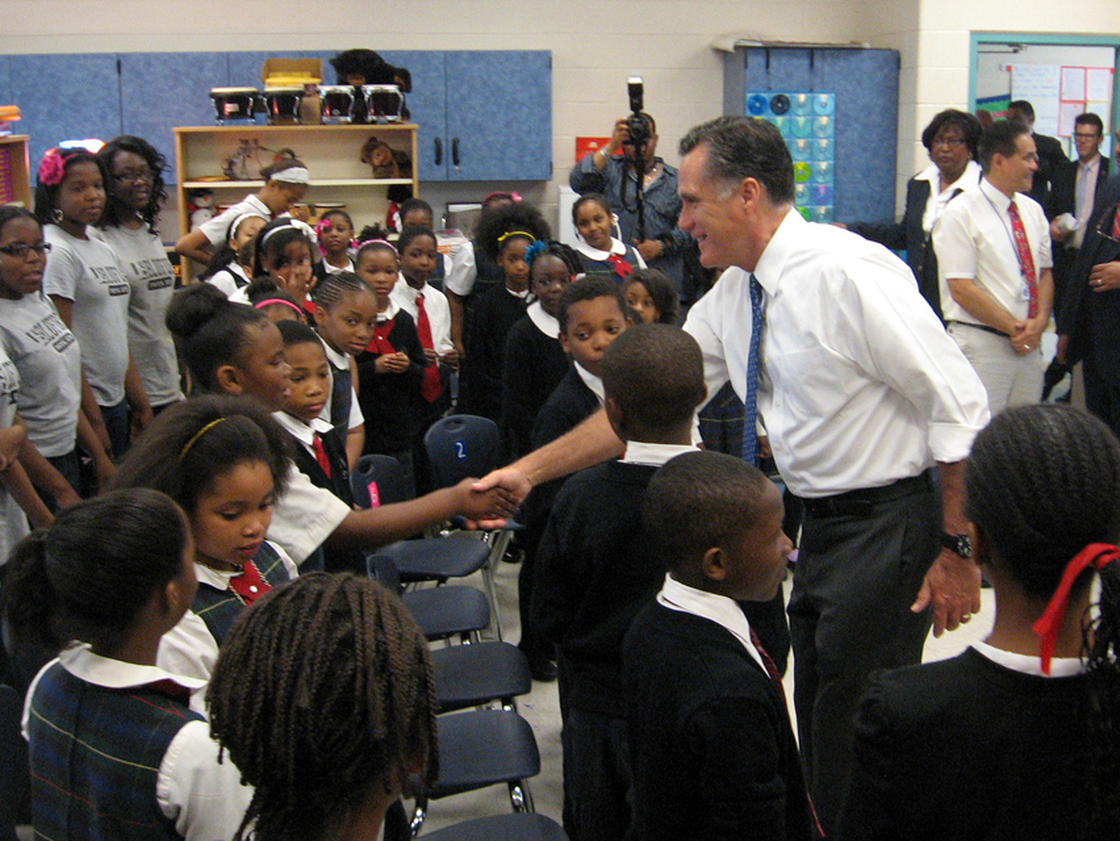 Romney greets a student at Universal Bluford Charter School, where he talked about education policy Thursday.