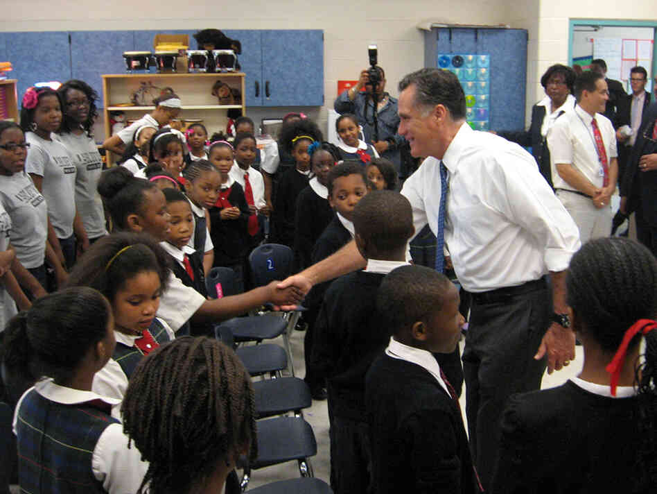 Romney greets a student at Universal Bluford Charter School, where he talked about education policy Thursday.