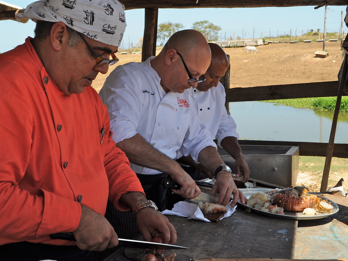 Pernot (center) cooks up a special dish.