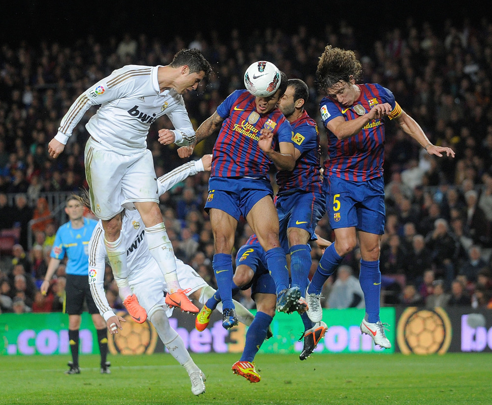 Spain's soccer teams are feeling the crunch of debt, too. But rich, winning teams like Real Madrid and Barcelona — seen here playing in April — are the most likely to stay in the game.