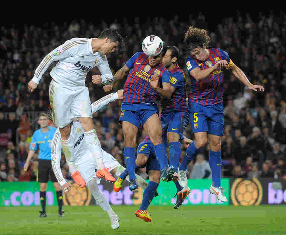Spain's soccer teams are feeling the crunch of debt, too. But rich, winning teams like Real Madrid and Barcelona — seen here playing in April — are the most likely to stay in the game.