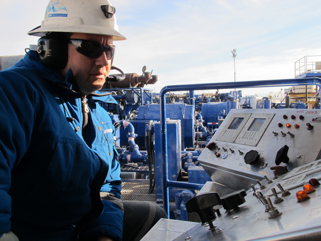 Oil workers in southern Argentina help guide a load of artificial sand that is then blasted at high pressure with waters and chemicals into a well, the process known as hydraulic fracturing, or fracking.