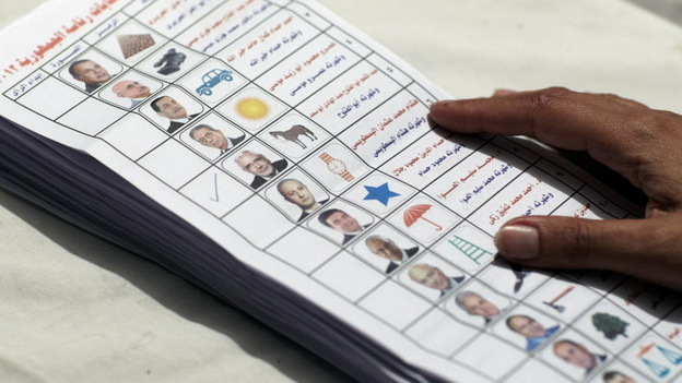 An Egyptian election official counting ballots from the presidential election.