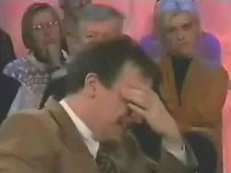 Interviewer laughing during an interview.