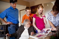 The Martin family (from left) — David; Chris, 14; Lauren, 12; and LaDonna — gather around AnnaBelle as they look through a photo album of a family vacation.