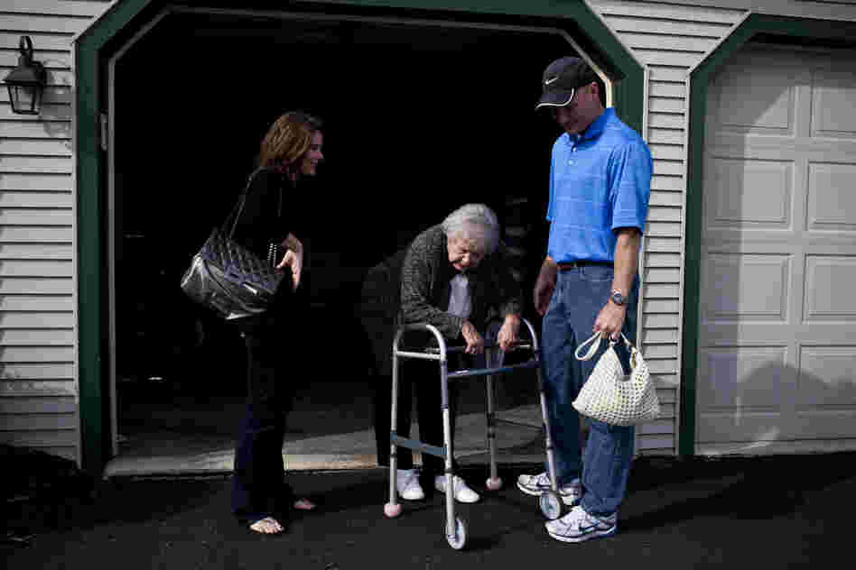 Kelley and her brother, David, wait for their grandmother to catch her breath as she moves from the living room to the car. AnnaBelle's mobility is significantly hampered by rheumatoid arthritis.