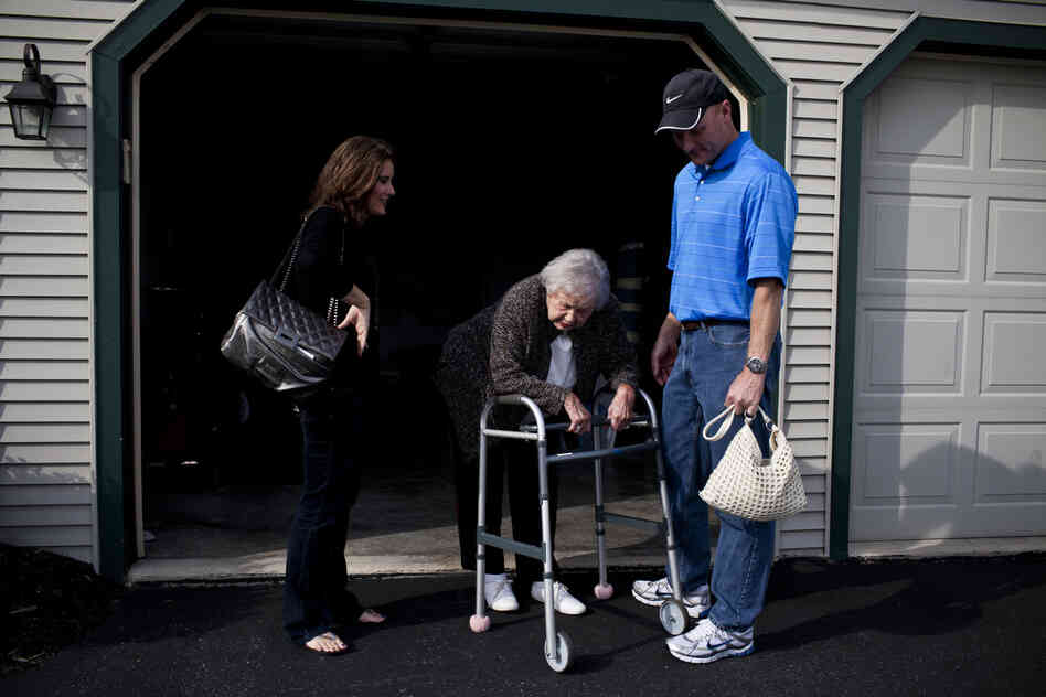 Kelley and her brother, David, wait for their grandmother to catch her breath as she moves from the living room to the car. AnnaBelle's mobility is significantly hampered by rheumatoid arthritis.