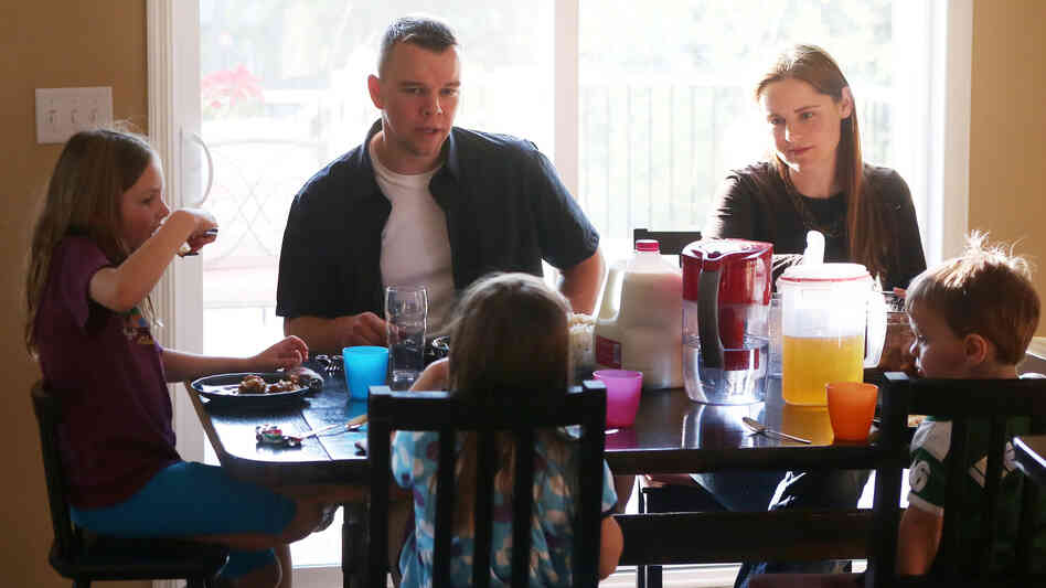 The Ross family eats dinner at their home in Mahtomedi, Minn. Kevin Ross joined the Minnesota National Guard in 1999. The Ross family eats dinner at their home in Mahtomedi, Minn. Kevin Ross joined the Minnesota National Guard in 1999.