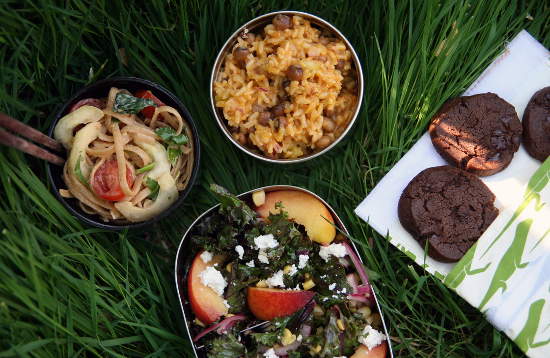 Picnic foods that were made to move: (clockwise from left) peanuty noodles, rice with pigeon peas, chocolate cookies and kale with peaches and feta.