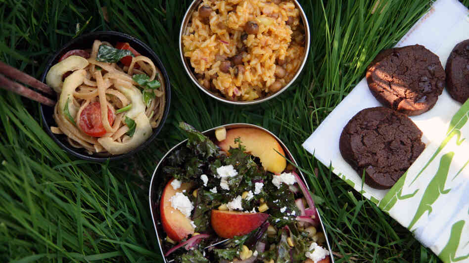 Picnic foods that were made to move: (clockwise from left) peanuty noodles, rice with pigeon peas, chocolate cookies and kale with peaches and feta.