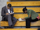 Job seekers fill out applications at a job fair in the Queens borough of New York City earlier this month. Economists say jobs in the middle — in sales, administration and assembly, for example — are being squeezed. Job seekers fill out applications at a job fair in the Queens borough of New York City earlier this month. Economists say jobs in the middle — in sales, administration and assembly, for example — are being squeezed.