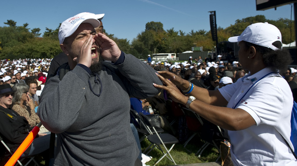An unidentified heckler lets loose as President Obama begins a speech at the Martin Luther King memorial dedication in Washington, D.C., in October 2011.