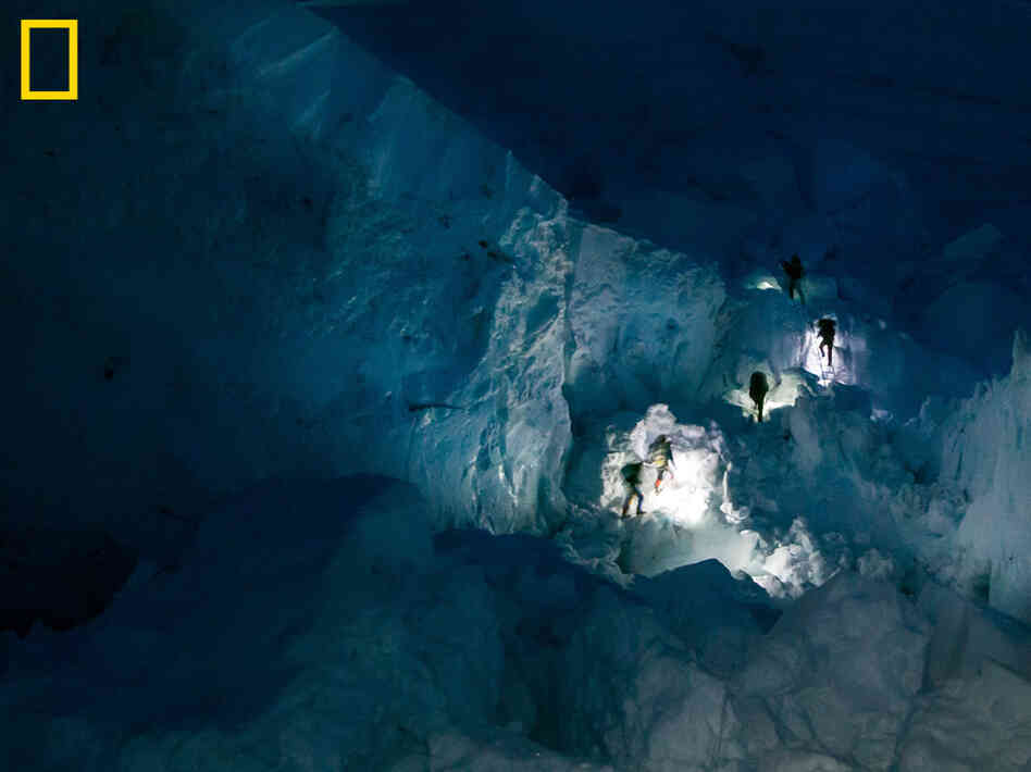 Sherpas' headlamps in the Khumbu Icefall early in the morning. You can see more at: http://ngm.nationalgeographic.com/everest/blog.
