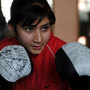 An Afghan girl takes part in a boxing training session around in a training room at the Kabul stadium, in Kabul in January 2011.