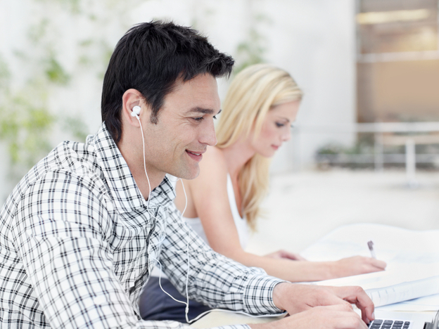 As headphones and earbuds become common in the workplace, sometimes even co-workers sitting next to each other are communicating online.