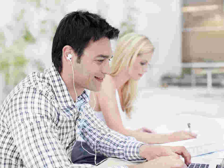 As headphones and earbuds become common in the workplace, sometimes even co-workers sitting next to each other are communicating online.