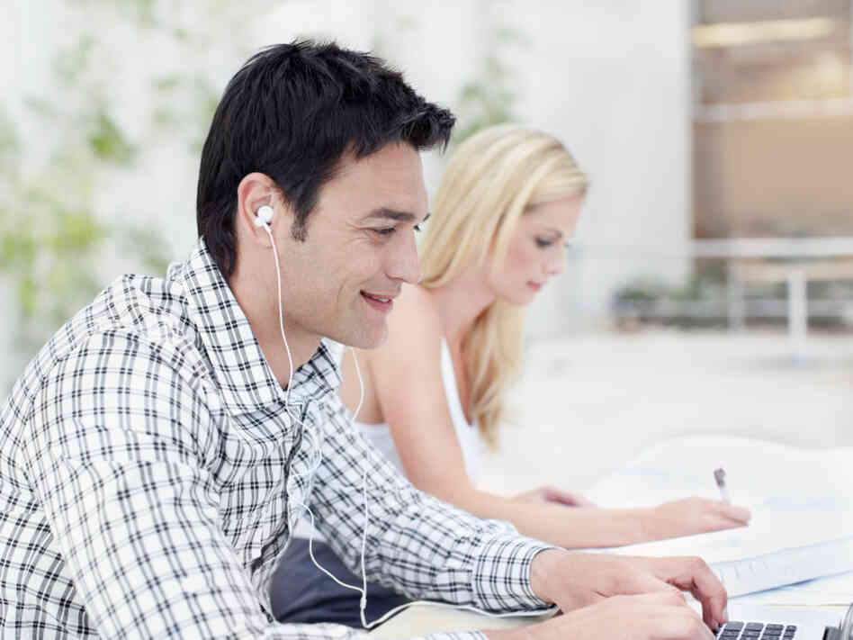 As headphones and earbuds become common in the workplace, sometimes even co-workers sitting next to each other are communicating online.