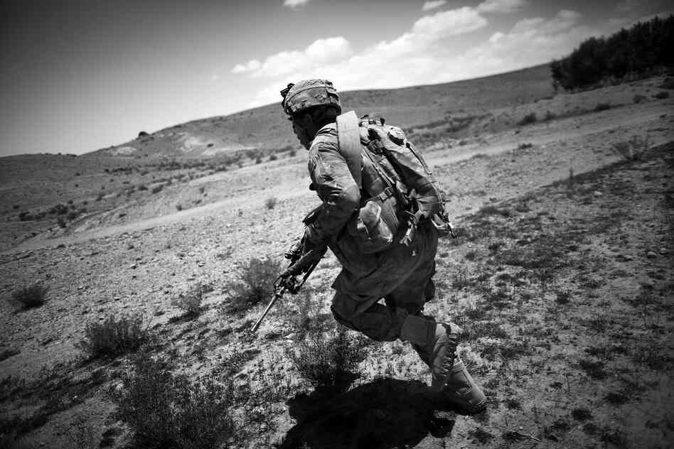 Pfc. John Ewing of Denver runs through incoming insurgent rounds during the battle in Babaker.