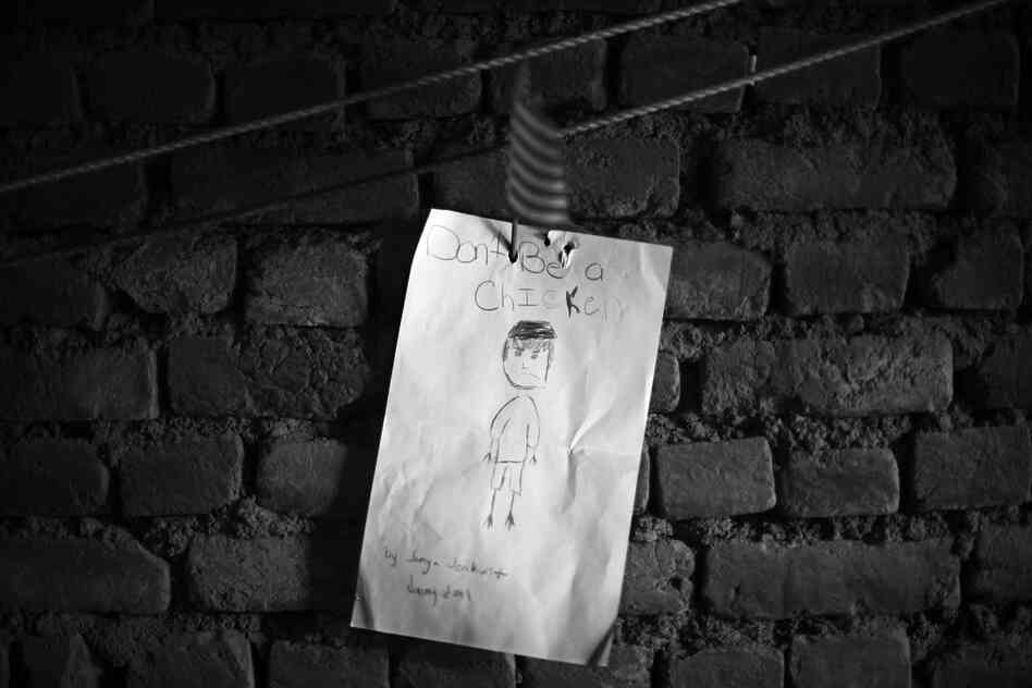 A letter written by a student in the U.S. and sent to the soldiers here is proudly displayed on the wall of the men's compound in Afghanistan. It reads "Don't Be a Chicken."