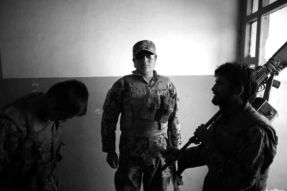 Zafar, an Afghan army soldier, waits in the doorway of what was once an elementary school for the village of Pana, but now serves as the soldiers' barracks and headquarters.