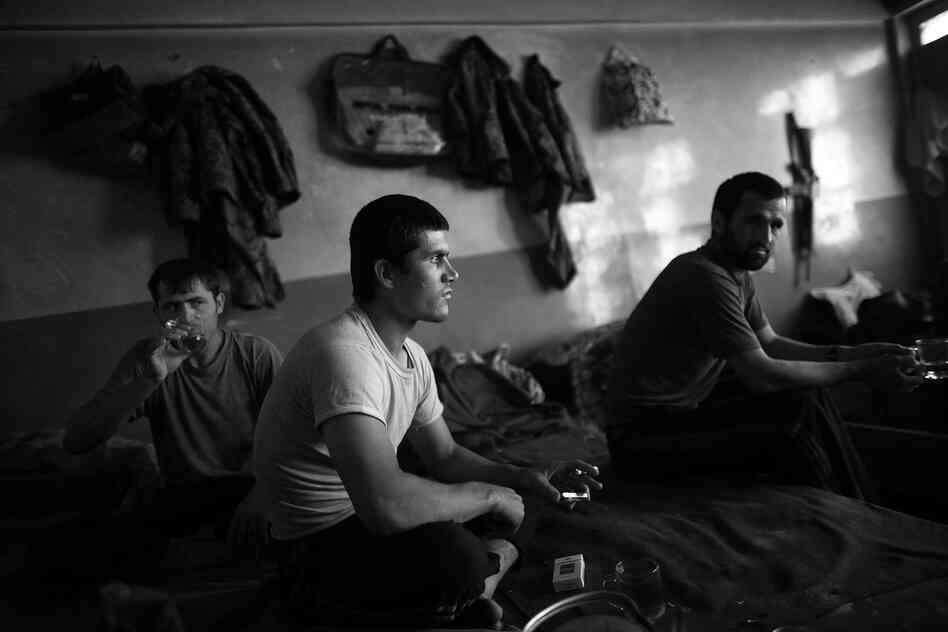 Abdul Khalik (center), from Badakhshan province in northern Afghanistan, shares a cup of tea with fellow Afghan army soldiers after Friday prayers in an old school building that they call home.