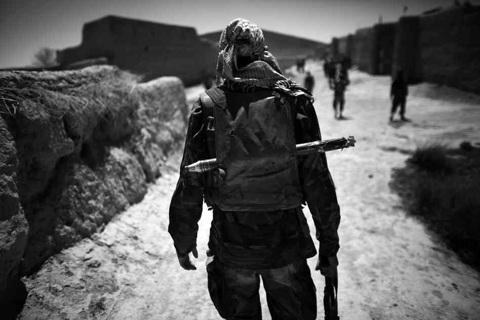 An Afghan soldier carries a backpack filled with extra ammunition and a spare rocket-propelled grenade while on a joint operation foot patrol with soldiers from the 82nd Airborne.