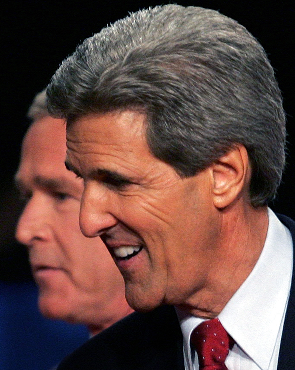 President George W. Bush passes behind Democratic challenger Sen. John Kerry, D-Mass., after a debate in Tempe, Ariz., in October 2004.