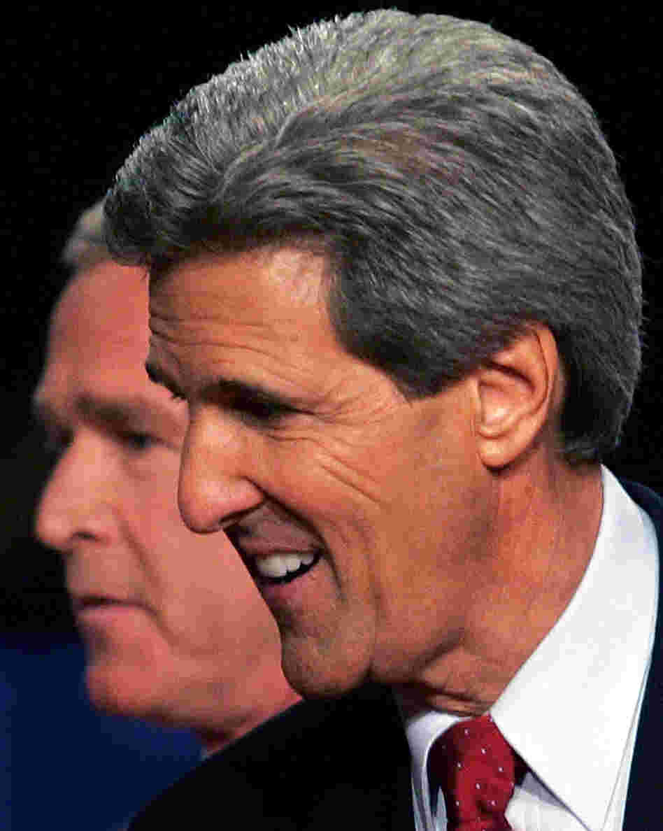 President George W. Bush passes behind Democratic challenger Sen. John Kerry, D-Mass., after a debate in Tempe, Ariz., in October 2004.