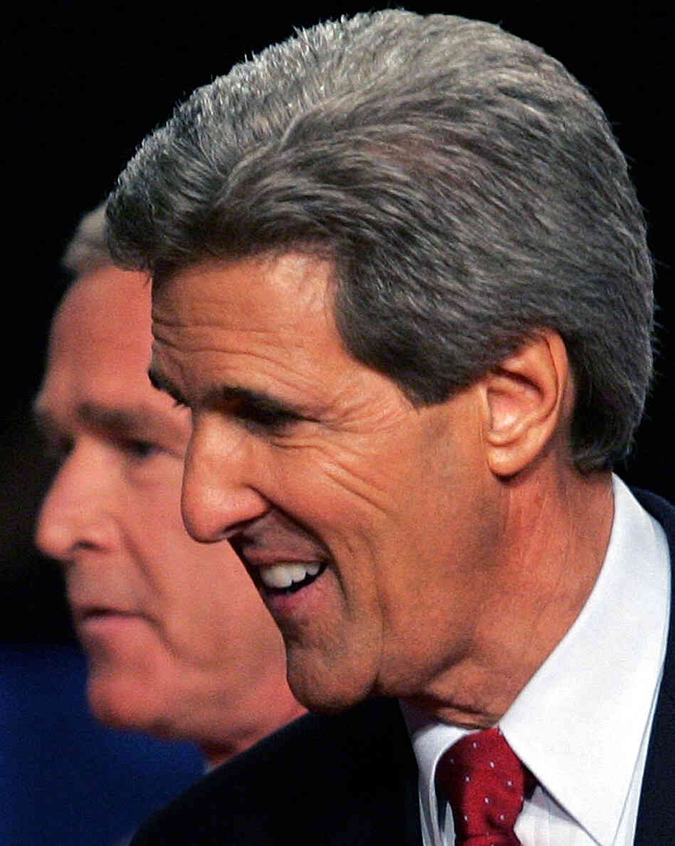 President George W. Bush passes behind Democratic challenger Sen. John Kerry, D-Mass., after a debate in Tempe, Ariz., in October 2004.