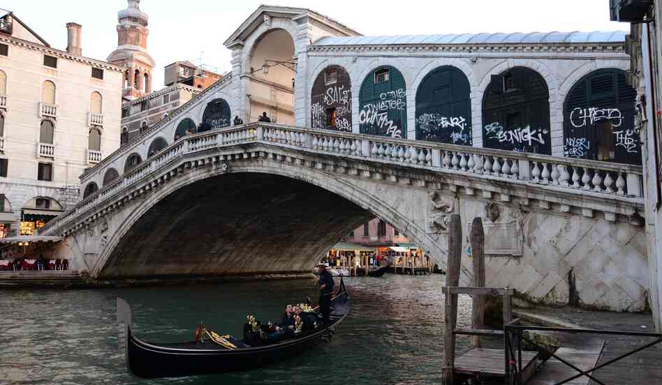 Graffiti on the wooden doors of the old studios on the Rialto Bridge in Venice, Italy. The Rialto bridge is the oldest bridge on the Canal Grande. According to Italian media reports, the incidence of graffiti on buildings and monuments in Venice is on to rise. Graffiti on the wooden doors of the old studios on the Rialto Bridge in Venice, Italy. The Rialto bridge is the oldest bridge on the Canal Grande. According to Italian media reports, the incidence of graffiti on buildings and monuments in Venice is on to rise.