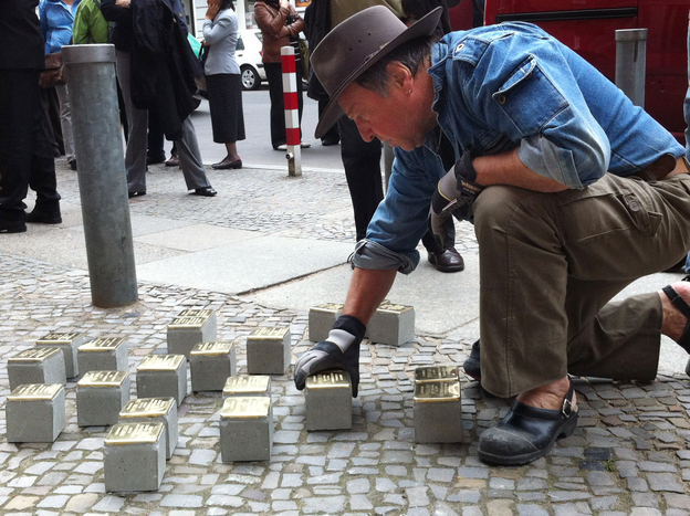 Guenther Demnig is the artist and sculptor behind the stumbling stones. Here, he installs new bricks in Berlin. He says formal memorials are too abstract. Not so with the stumbling stones. "Suddenly they are there, right outside your front door, at your feet, in front of you," he says.