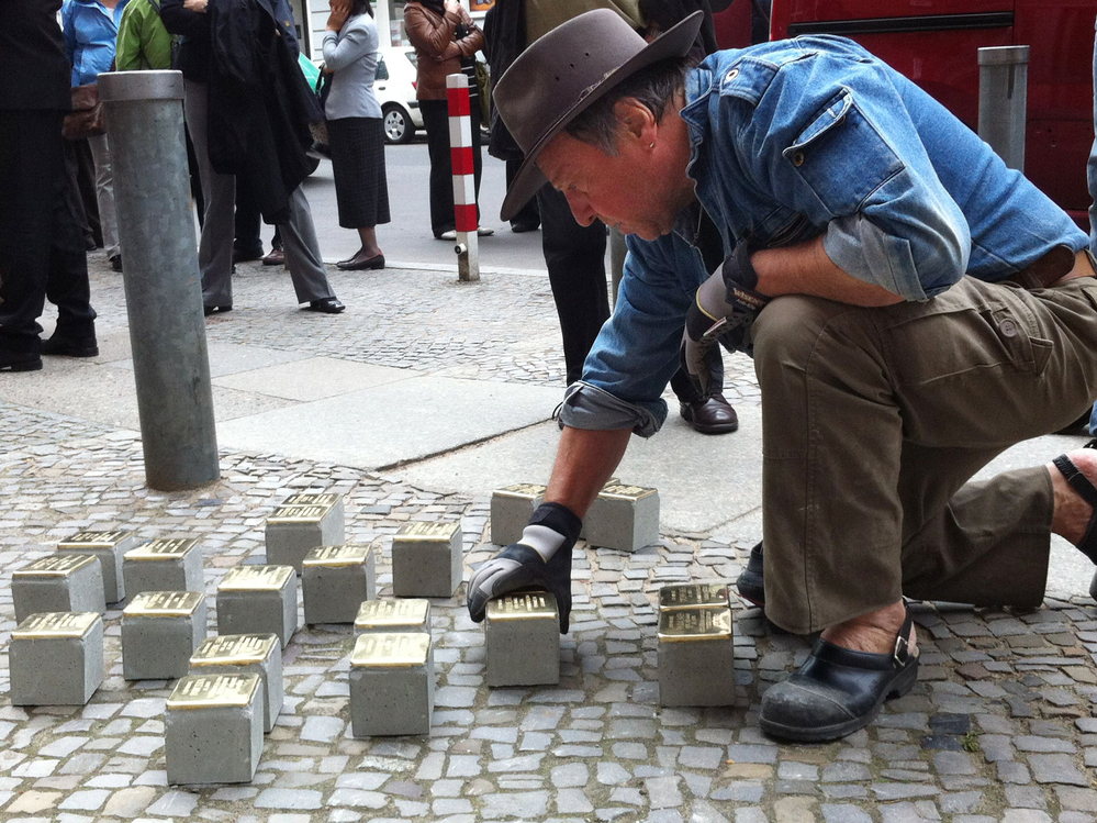 Guenther Demnig is the artist and sculptor behind the stumbling stones. Here, he installs new bricks in Berlin. He says formal memorials are too abstract. Not so with the stumbling stones. "Suddenly they are there, right outside your front door, at your feet, in front of you," he says.