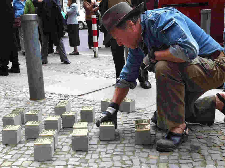 Guenther Demnig is the artist and sculptor behind the stumbling stones. Here, he installs new bricks in Berlin. He says formal memorials are too abstract. Not so with the stumbling stones. "Suddenly they are there, right outside your front door, at your feet, in front of you," he says.