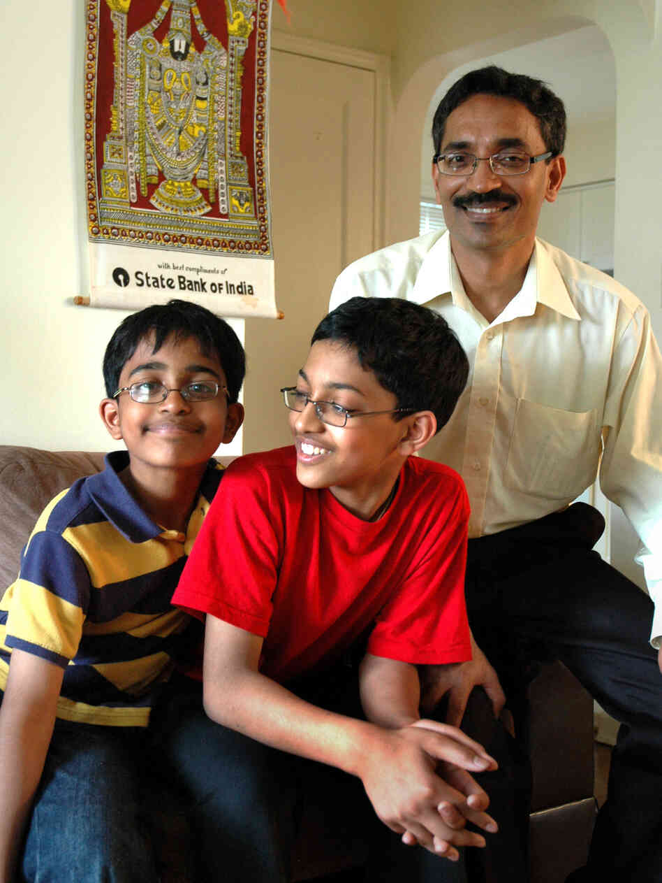 Arvind (center) and his younger brother, Srinath, spend hours tediously going through the dictionary.