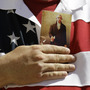 A demonstrator holds a copy of the U.S. Constitution to his chest as he attends a protest in downtown San Antonio on March 23.