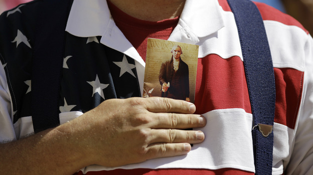 A demonstrator holds a copy of the U.S. Constitution to his chest as he attends a protest in downtown San Antonio on March 23.