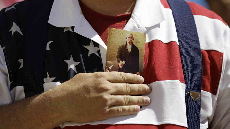 A demonstrator holds a copy of the U.S. Constitution to his chest as he attends a protest in downtown San Antonio on March 23.