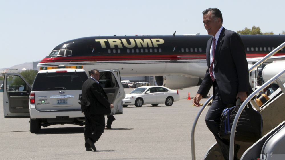 Republican presidential candidate Mitt Romney walks past Donald Trump's airplane as he arrives in Las Vegas on Tuesday, where he met with Trump for a fundraiser.