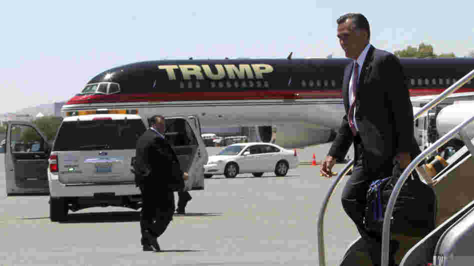Republican presidential candidate Mitt Romney walks past Donald Trump's airplane as he arrives in Las Vegas on Tuesday, where he met with Trump for a fundraiser.