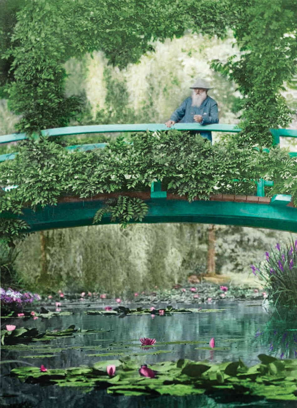 This 1922 colorized photograph shows Monet on the original Japanese footbridge in Giverny.