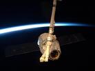 The SpaceX Dragon module, held by the International Space Station's robotic arm. The SpaceX Dragon module, held by the International Space Station's robotic arm.