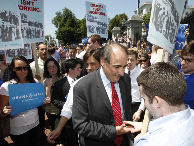 David Axelrod, the Obama campaign's senior strategist (center), stops to shake a demonstrator's hand as he leaves a news conference at the Massachusetts State House in Boston on Thursday.