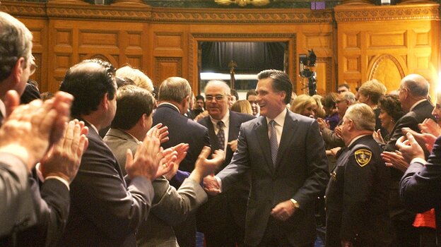 Mitt Romney shakes hands as he walks into the House Chambers during inaugural ceremonies at the State House in Boston in 2003. the Obama campaign sought to focus attention on Romney's tenure as Massachusetts governor.