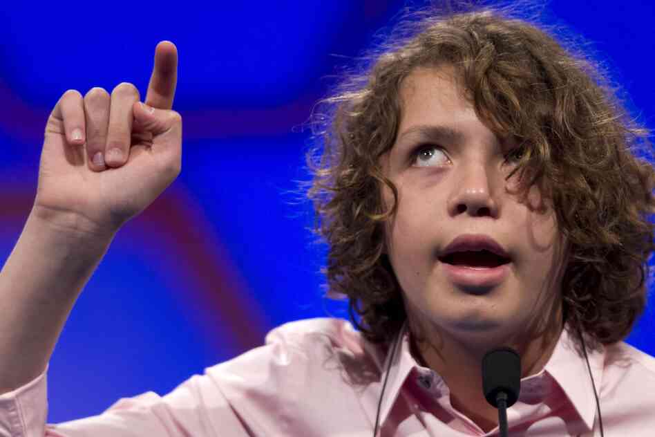 Sam Lowery, of Charlestown, Mass., spells his word in the air during Round 2 of the National Spelling Bee in Oxon Hill, Md., on Wednesday.