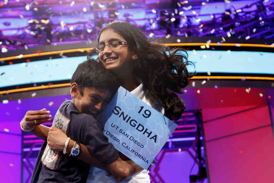 With confetti falling, Snigdha Nandipati, 14, is embraced by her brother, Sujan Nandipati, after she won the National Spelling Bee with the word "guetapens" Thursday.