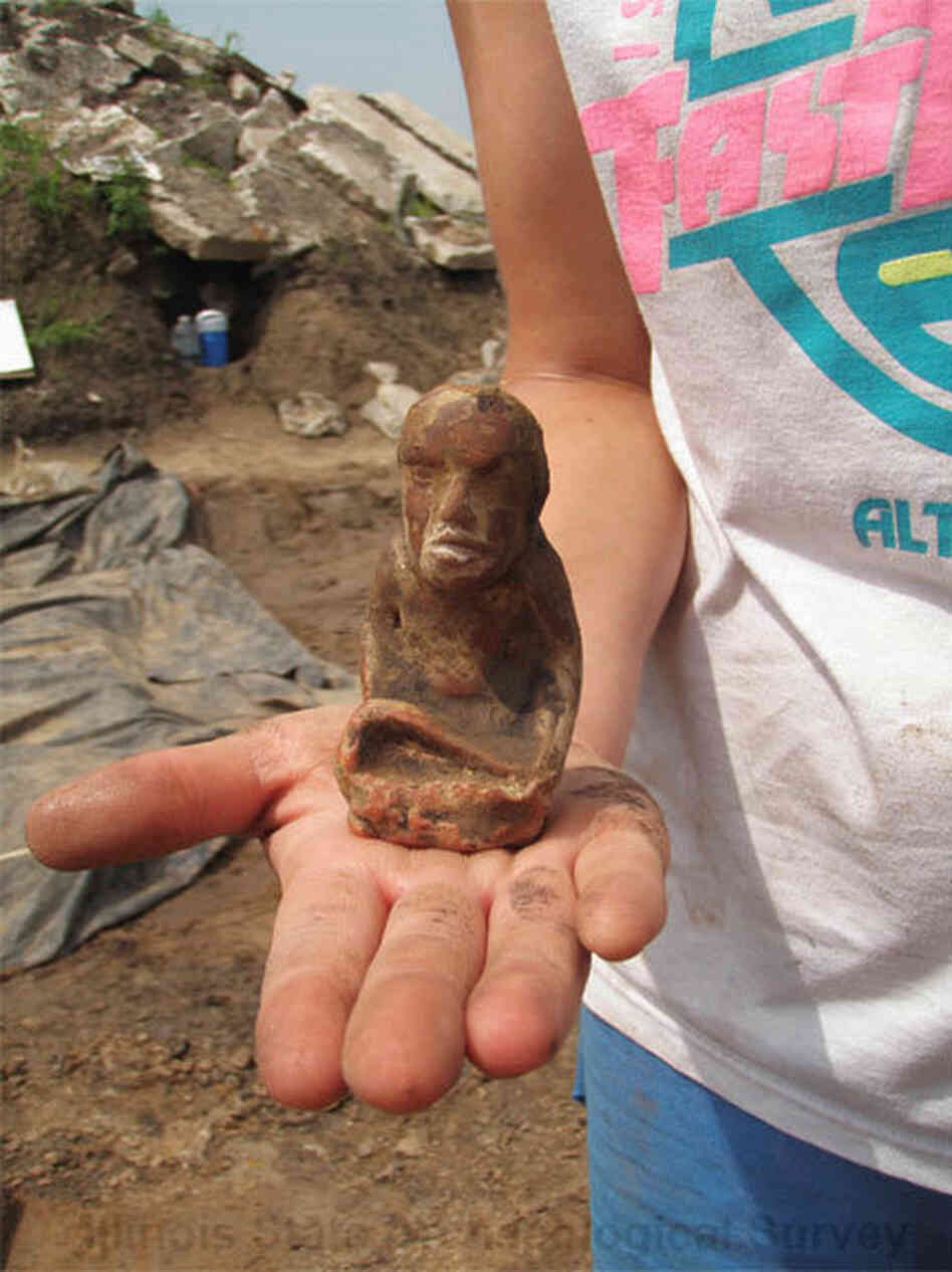 This figurine found at the East St. Louis dig site is made of a type of pipestone called Missouri flint clay. It portrays a kneeling woman holding a marine shell cup — possibly a fertility goddess.