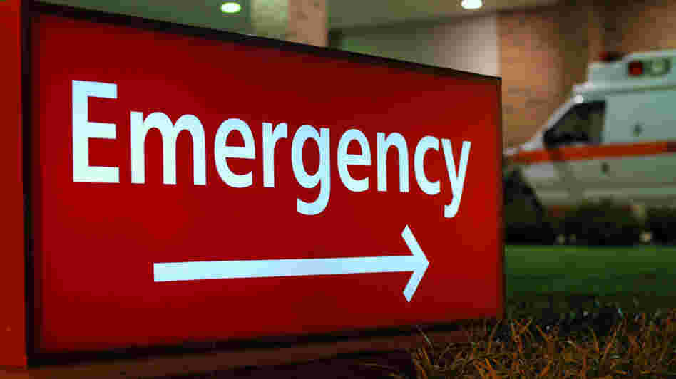 A sign points the way to a hospital emergency room. A sign points the way to a hospital emergency room.