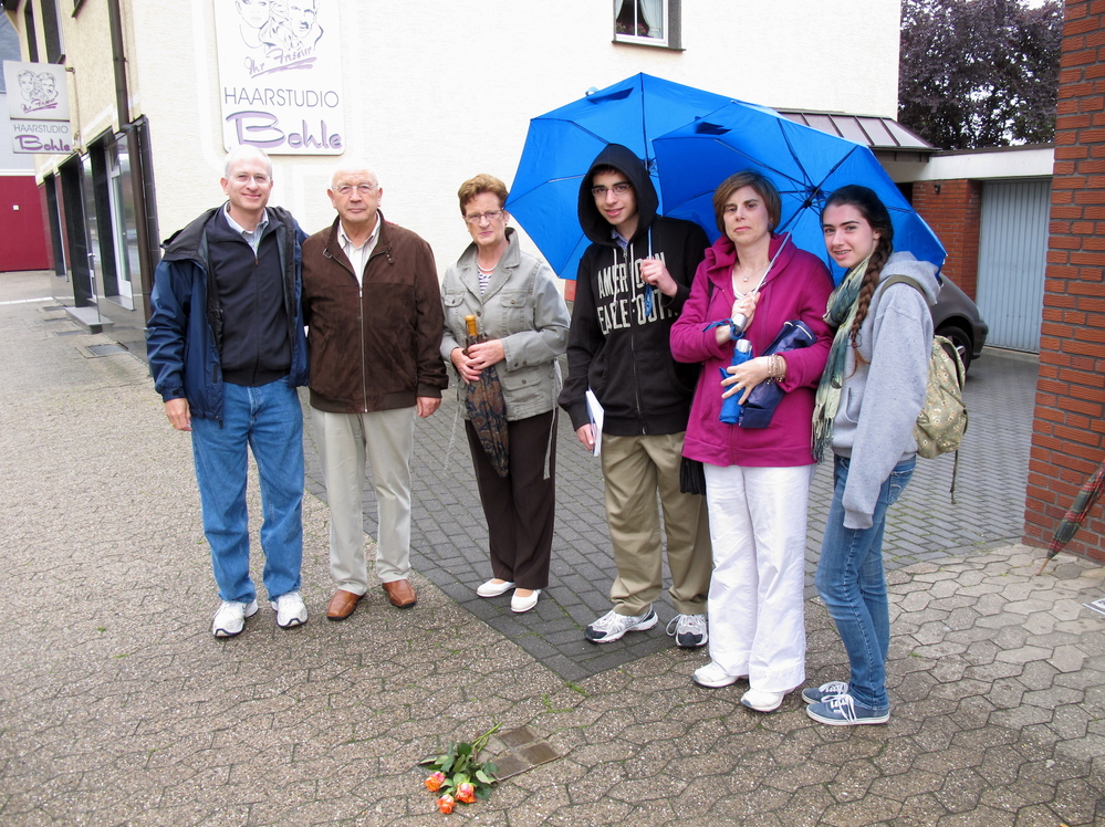 Jeffrey Katz (far left), NPR's deputy managing editor for Digital News, stands next to "stumbling stones" in Lembeck, Germany, that include names of family members evicted from their home during the Holocaust. With him, from left to right: Josef Langenhorst (who was age 7 when he saw the family being removed);  Langenhorst's wife; and Katz' family — son Ben, wife Mollie and daughter Emily.
