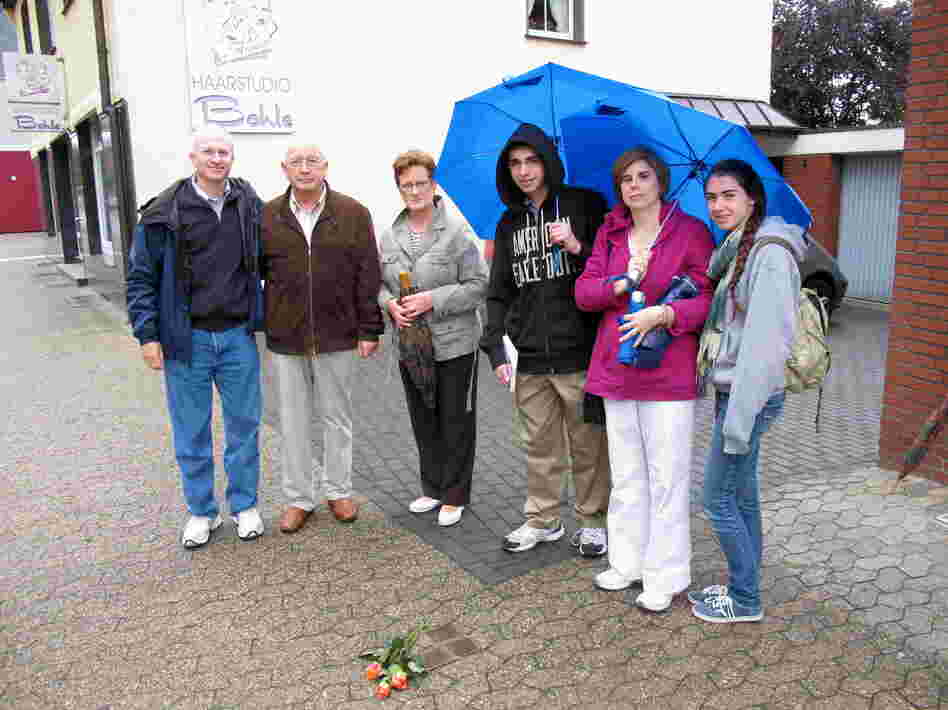 Jeffrey Katz (far left), NPR's deputy managing editor for Digital News, stands next to "stumbling stones" in Lembeck, Germany, that include names of family members evicted from their home during the Holocaust. With him, from left to right: Josef Langenhorst (who was age 7 when he saw the family being removed);  Langenhorst's wife; and Katz' family — son Ben, wife Mollie and daughter Emily.
